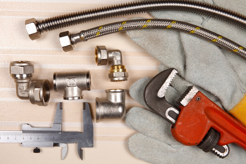 Plumber working on pipes in a Dulwich home